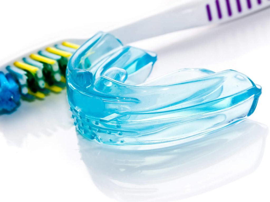 A mouth guard and tooth brush
