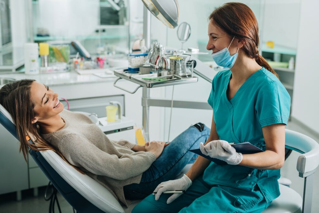Dental hygienist talking with patient